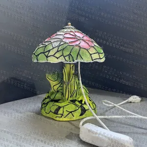Detail view of Tiffany style mushroom lamp with floral stained glass and tree trunk base