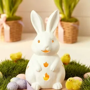 White ceramic bunny candle holder with tulip cutouts and warm glowing light decoration