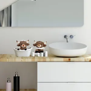 Highland cow bathroom resin figures set in a white bathtub with mini toilet paper decor