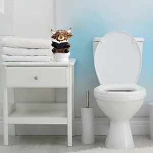 Humorous resin Highland Cow statue sitting on a miniature toilet reading a book decor