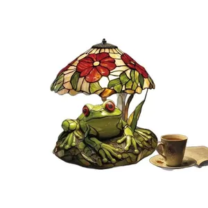 Tiffany style resin lamp with green frog base and colorful floral stained glass shade