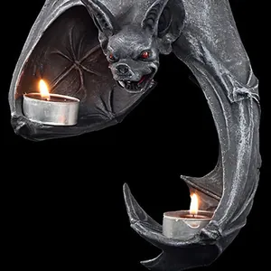 Close-up of gothic bat tealight holder with red eyes and detailed resin wings