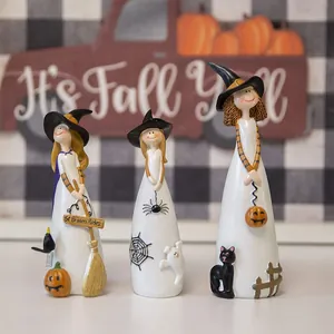 Three cute Halloween resin witch figurines with broom and pumpkins for home fall decor