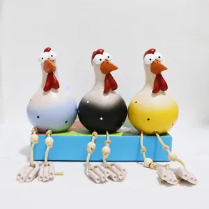 Three resin goofy chickens with dangling rope legs and big eyes for garden decor