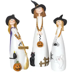 Three cute resin witch figurines with black hats and pumpkins for Halloween home decor
