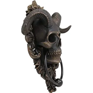 Side view of gothic resin ram skull wall plaque with bronze finish and metal ring knocker