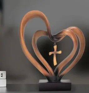 Detail of wooden texture heart sculpture with a hanging metal cross on a black base