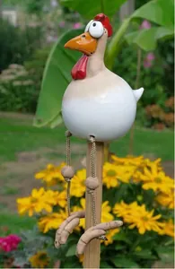 Detailed view of resin hanging chicken garden statue with dangling rope legs and big eyes
