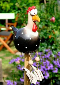 Close-up of decorative resin chicken garden ornament with big eyes and polka dot body