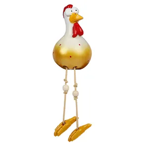 Detail of creative resin chicken figurine with long hanging legs and red polka dots