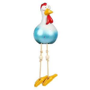 Detailed view of resin chicken figurine with blue polka dots and hanging wooden bead legs