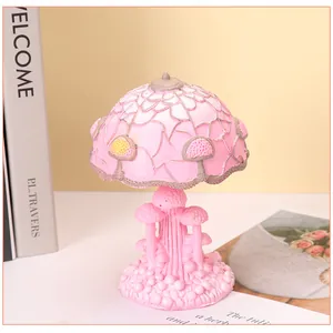 Macro detail of pink resin mushroom lamp base showing intricate textures and carvings