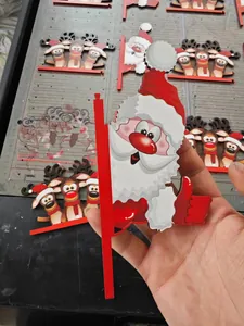 Close-up of wooden Santa and reindeer door corner hangers with vibrant colorful printing