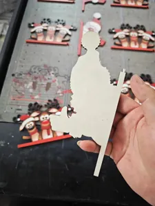 Detail of laser-cut wooden reindeer door ornaments with festive Christmas hats