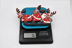 Detail shot of a 36g wooden Santa and reindeer door frame ornament on a scale