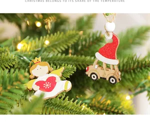 Close-up of wooden angel and car ornaments hanging on a Christmas tree with LED lights