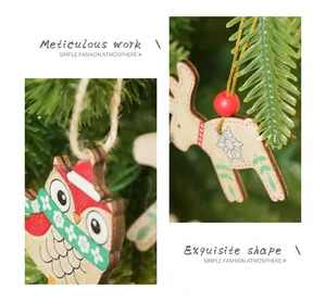 Detailed view of wooden Christmas ornaments featuring elk and owl designs on a tree