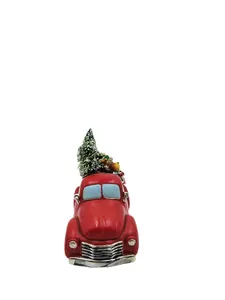 Detailed view of red vintage truck resin ornament with a mini Christmas tree