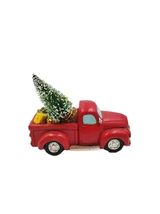 Detail of red vintage resin truck featuring a miniature snow-frosted Christmas tree
