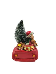 Miniature red vintage pickup truck figurine with Christmas tree and festive decor