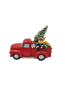 Red Christmas truck figurine with reindeer, Xmas tree and gifts on white background