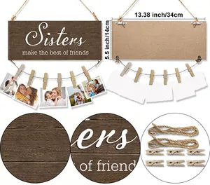Detail of wooden photo frame with sisters quote and hanging clips for wall decor