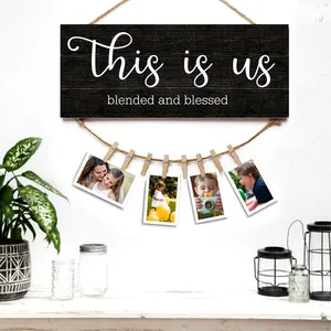 Rustic wooden photo display board with hemp rope and clips featuring This Is Us lettering