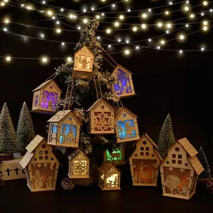 Illuminated wooden Christmas house ornament with LED light and cutout festive patterns