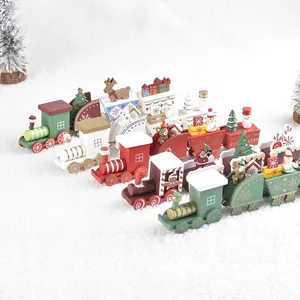 Handcrafted wooden Christmas train set with snowman and reindeer decor on faux snow