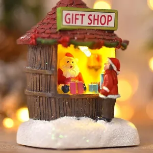 Miniature Christmas resin gift shop house with Santa Claus and warm glowing LED lights