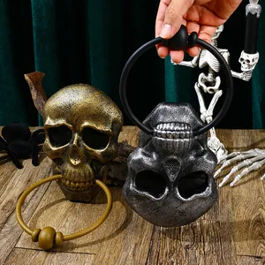 Detail of vintage skull door knockers in bronze and silver for Halloween party decor