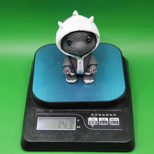 Detail showing high-quality resin dragon figurine on scale weighing exactly 143 grams