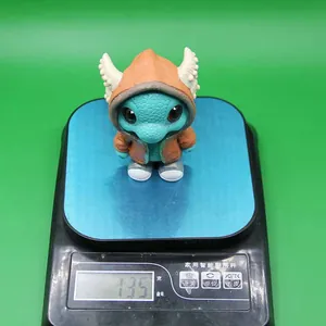 Detailed view of 135g cute dragon resin figurine on electronic scale with green background