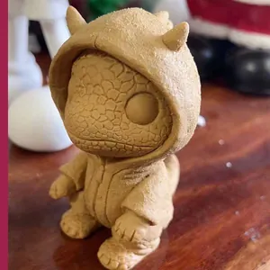 Detailed macro shot of the scaly texture on a brown resin monster figurine with a hood