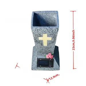 Detailed view of stone-texture memorial vase with solar panel and yellow cross relief