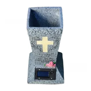 Close-up of solar cross cemetery vase with pink roses and engraved memorial text