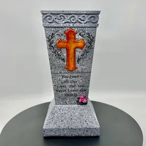 Detail of stone texture memorial plaque with gold cross and heart touching quote