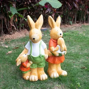 Detailed view of resin rabbit family statues with wood-like texture on outdoor lawn