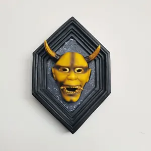 3D yellow Hannya mask wall art with golden horns and fangs on a black hexagonal frame