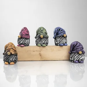 Detailed view of five colorful resin garden gnomes with textured beards on wood