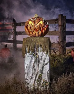 Detailed view of Halloween glowing pumpkin with wood texture and silver snake on stone pedestal