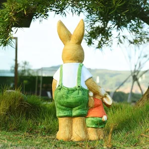 Charming resin rabbit garden statues with colorful outfits on a lush lawn landscape