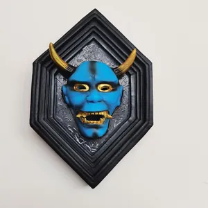 Blue Hannya mask wall decor with golden horns in a black hexagonal frame