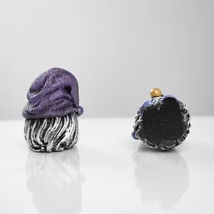 Detail view of gnome resin figures showing back texture and flat black base base