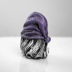 Detailed close-up showing the textured purple hat and carved resin beard of a garden gnome