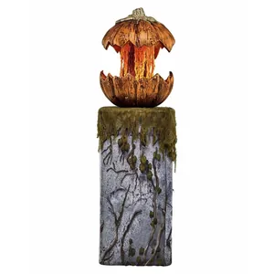 Close-up of Halloween pumpkin light on stone pillar base with moss and vine details