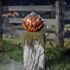 Spooky Halloween pumpkin lantern decor on stone pedestal for outdoor garden party vibes