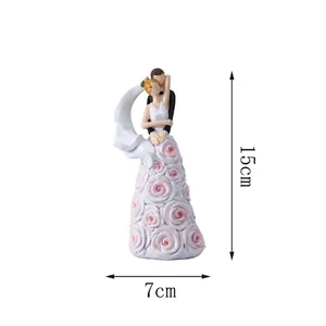 Detail showing 15cm height and 7cm width dimensions of a resin wedding couple figurine
