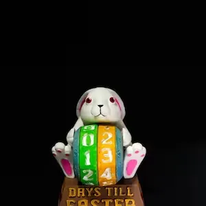 Close-up of Easter bunny countdown resin ornament with adjustable date dial on base