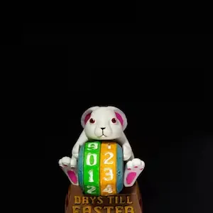 Close-up of a resin Easter bunny countdown calendar with adjustable number wheels